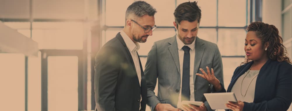 Three professionals from the business world talking together.