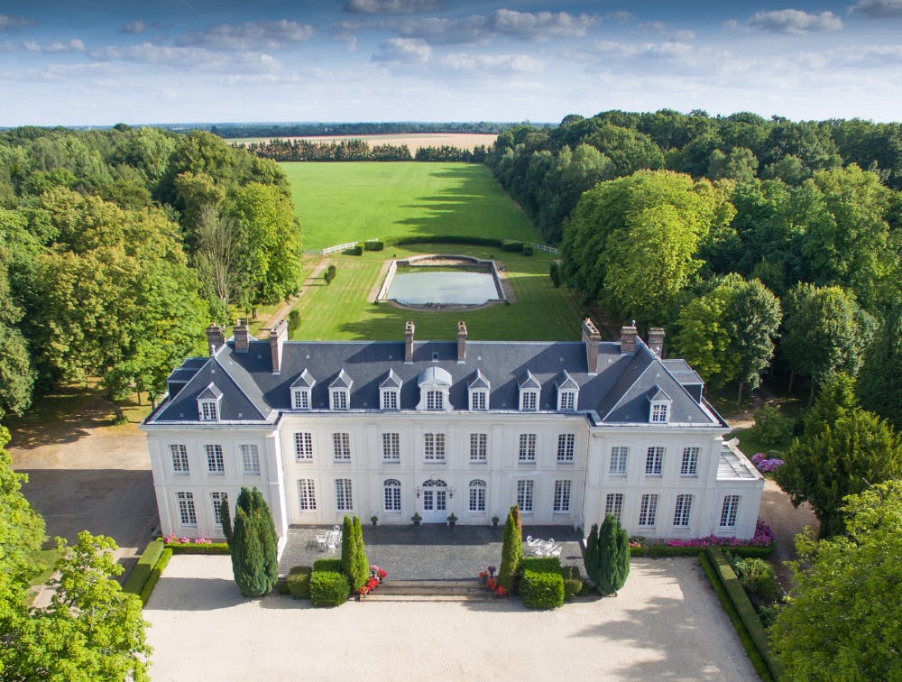 The Domaine du Tremblay, a castle located in Normandie, surrounded by large green spaces.